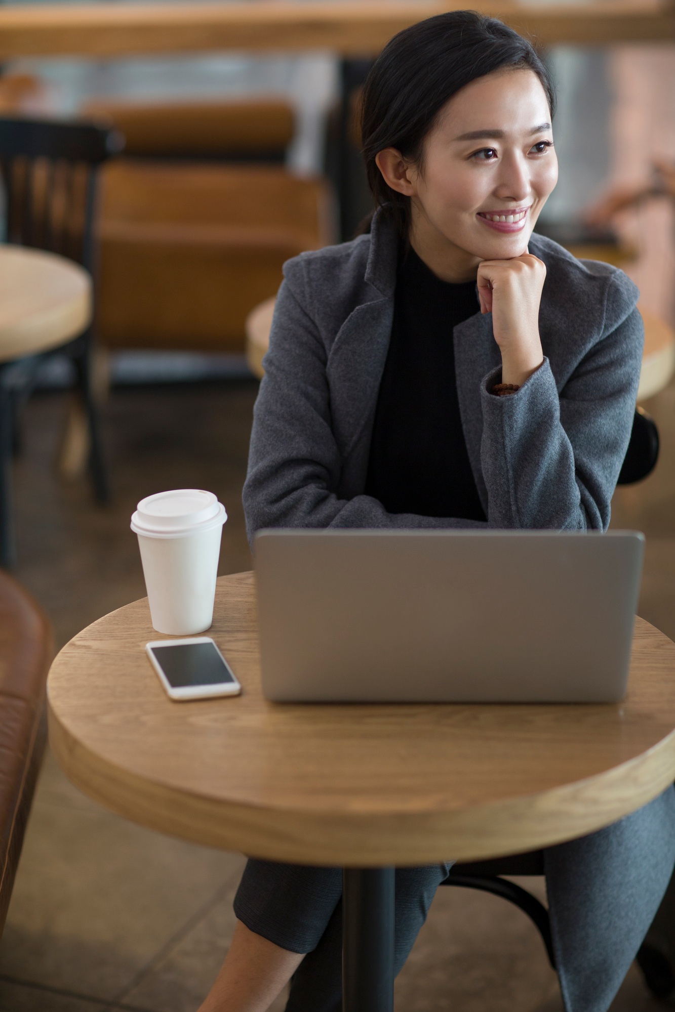 Businesswoman using laptop at the airport