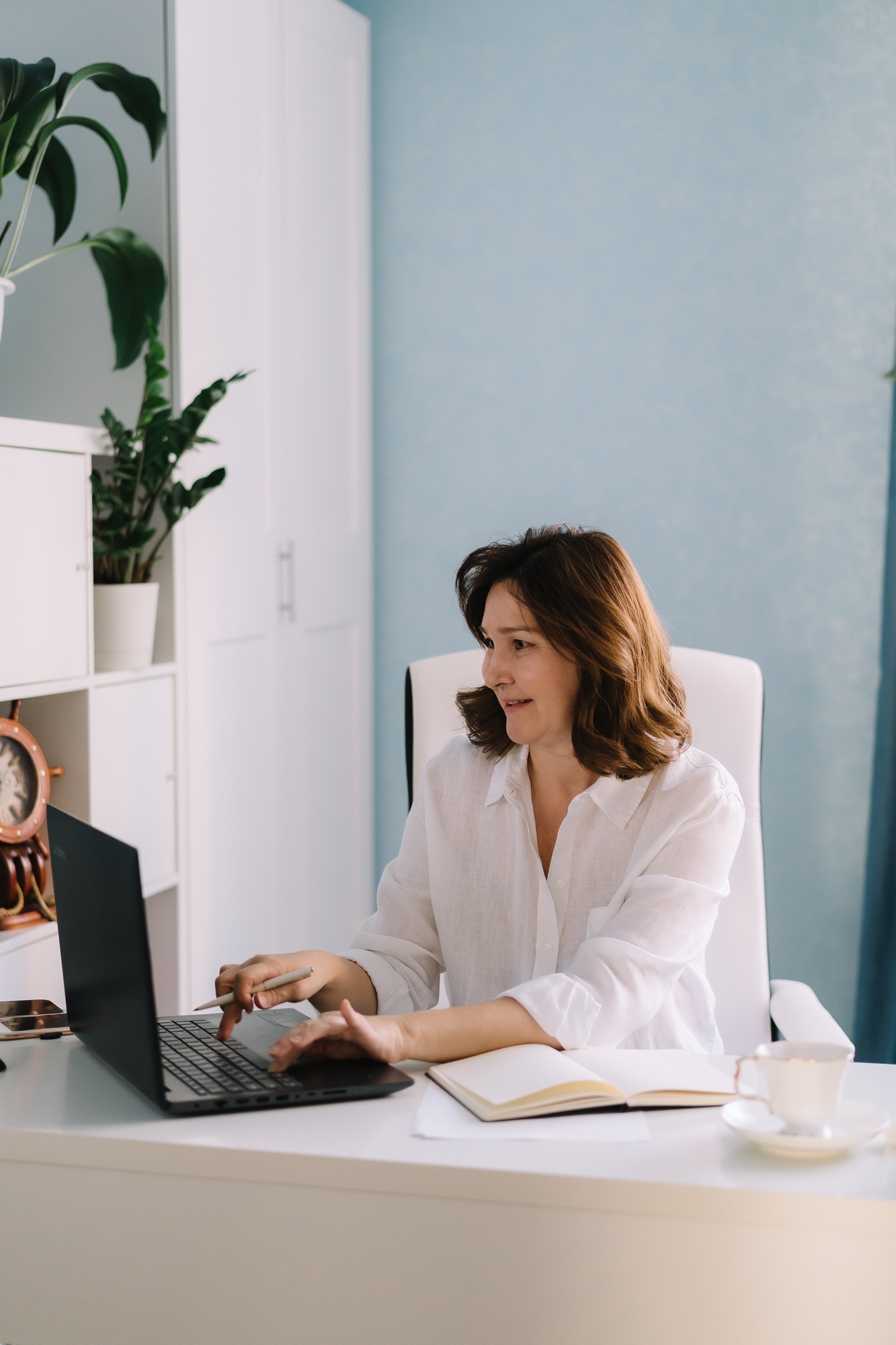 Happy businesswoman working typing on pc at home office